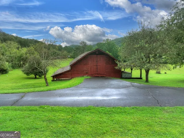 a kitchen with stainless steel appliances granite countertop a stove a sink dishwasher and cabinets with wooden floor