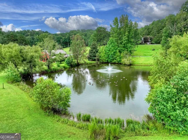 a kitchen with stainless steel appliances granite countertop a refrigerator a sink a stove and dishwasher