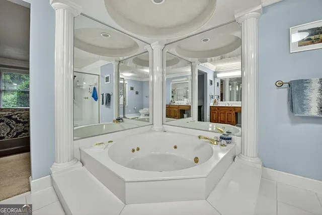 a spacious bathroom with a granite countertop sink mirror and