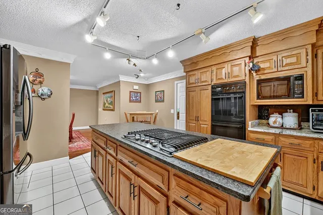 a living room with furniture a bookshelf and a window