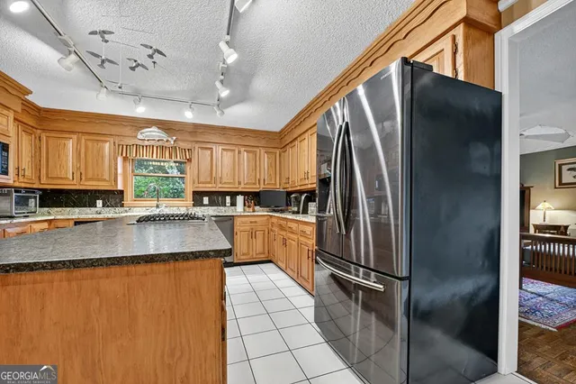 a view of a lush green forest with trees and some houses
