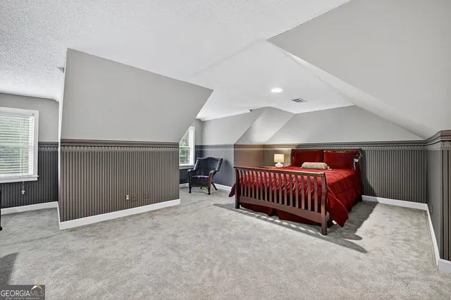 a view of an empty room with window and bathroom