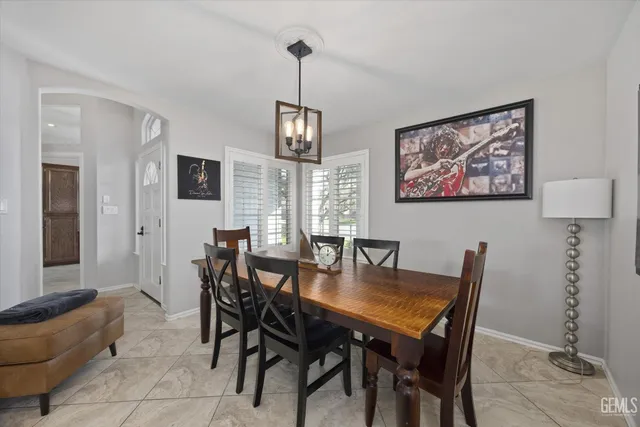 a bedroom with a bed couch and windows