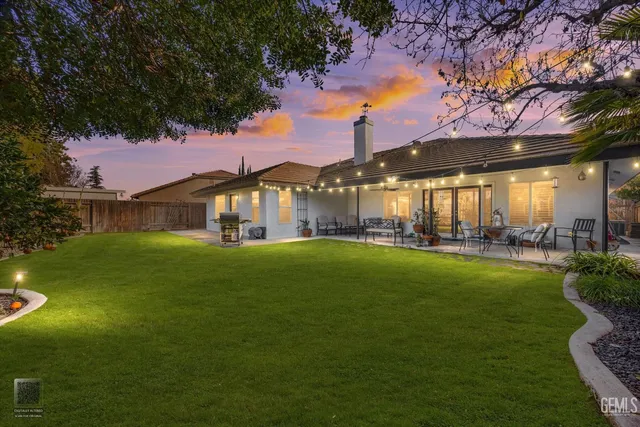 a front view of a house with swimming pool having outdoor seating