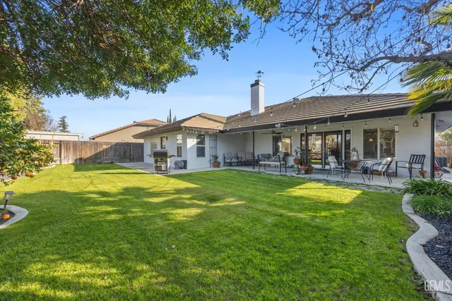 a view of a patio with couches table and chairs and potted plants