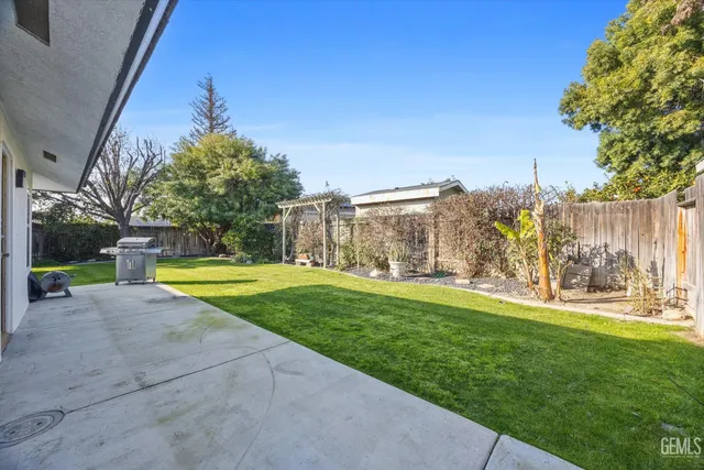 a view of backyard with swimming pool