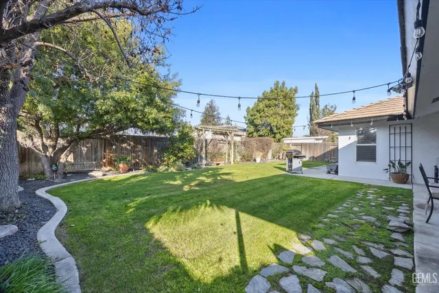 a swimming pool with outdoor seating and yard
