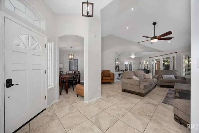 a living room with furniture and a ceiling fan