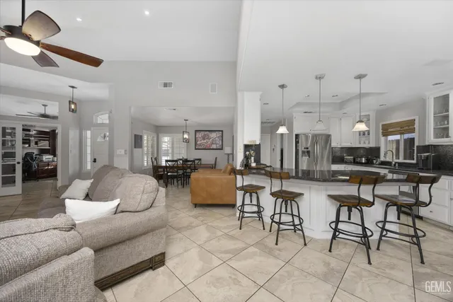 a living room with furniture and kitchen view