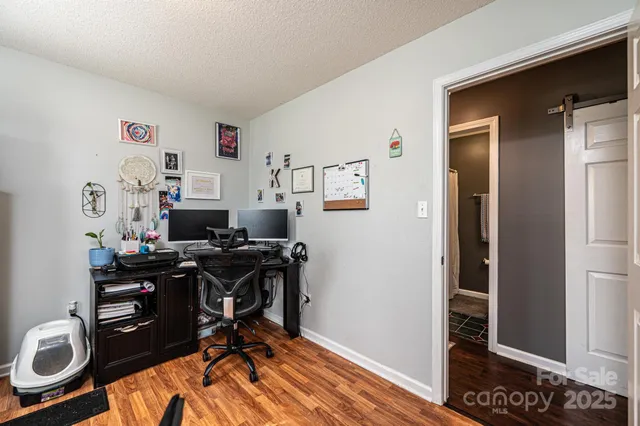 a view of a workspace with furniture and a window