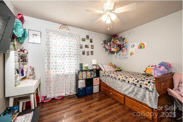 a bedroom with baby toys and wooden floor