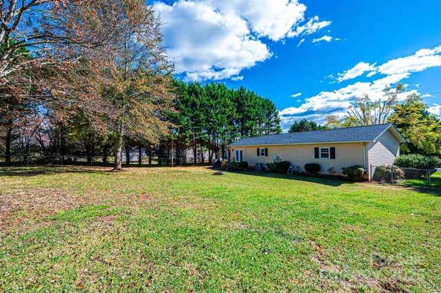 a front view of house with yard and trees