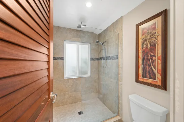 a bathroom with a shower toilet and sink