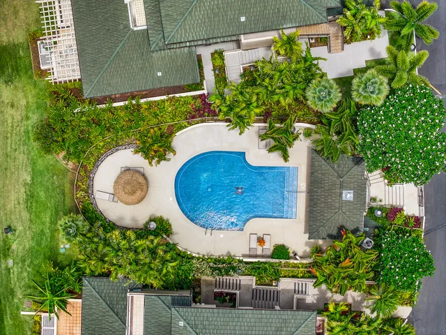 a view of a house with a backyard and a garden
