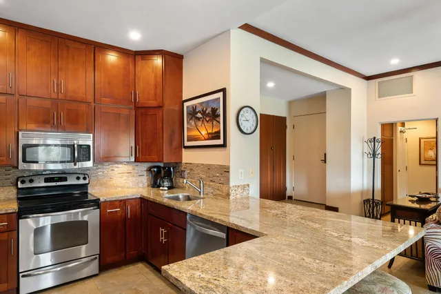 a kitchen with stainless steel appliances a stove microwave and cabinets