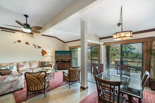 a living room with furniture a ceiling fan and a window
