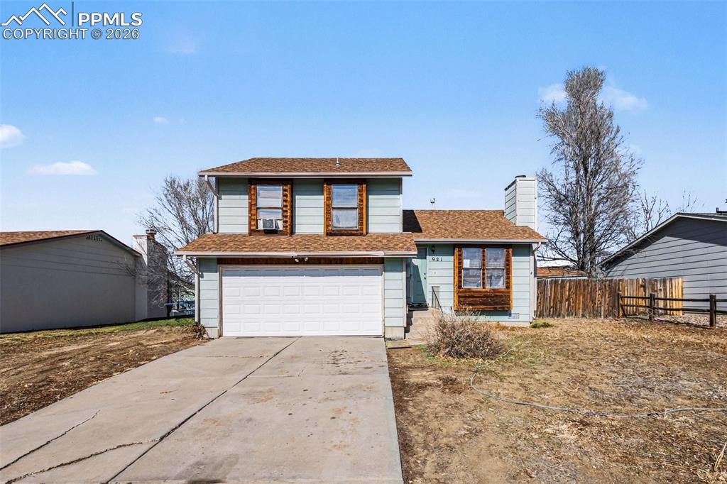 921 Candlestar Loop North Fountain, CO 80817 - Photo 1 of 23 a front view of a house with a yard and garage