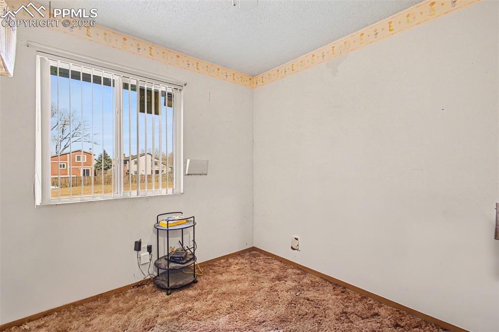 921 Candlestar Loop North Fountain, CO 80817 - Photo 13 of 23 a view of a room with rack on the wall and a window