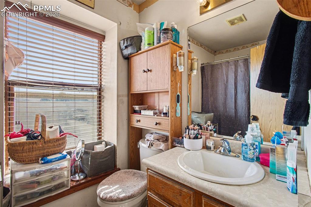 921 Candlestar Loop North Fountain, CO 80817 - Photo 16 of 23 a bathroom with a sink a toilet and tub