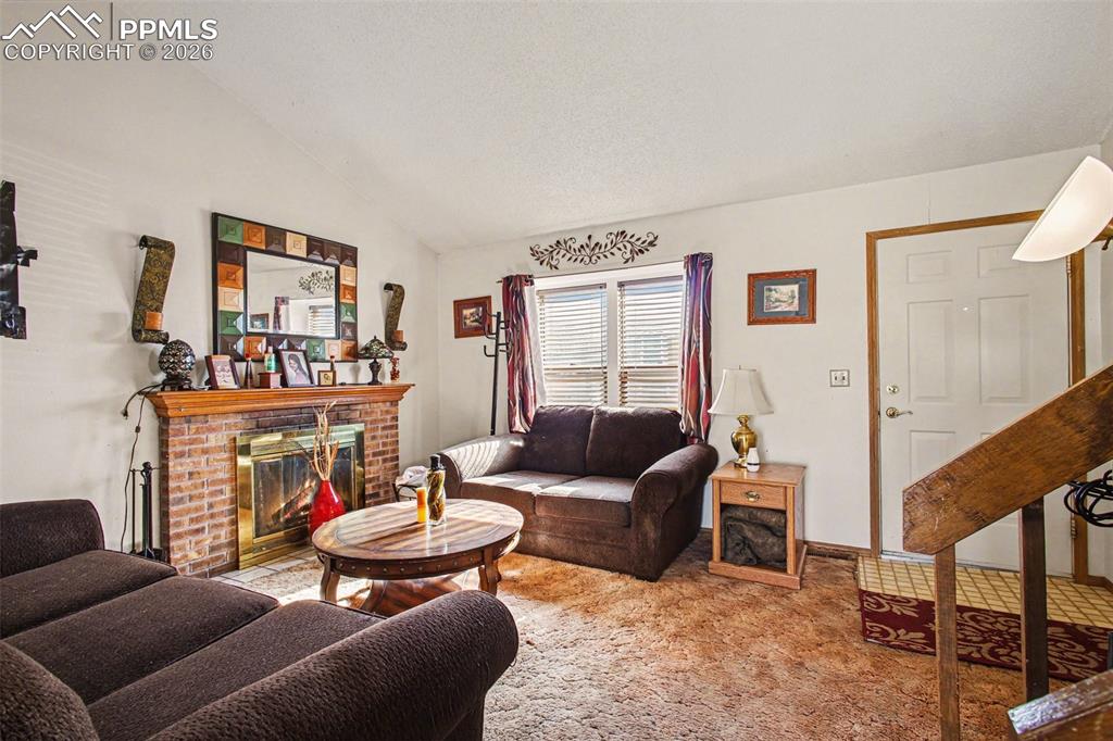 921 Candlestar Loop North Fountain, CO 80817 - Photo 5 of 23 a living room with furniture and a fireplace