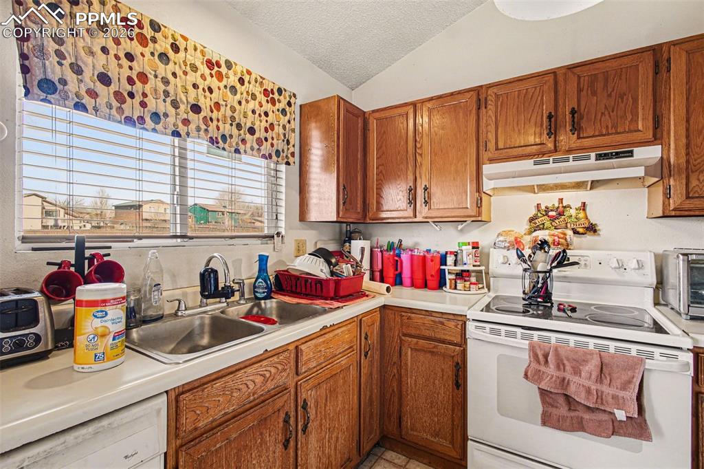 921 Candlestar Loop North Fountain, CO 80817 - Photo 8 of 23 a kitchen with stainless steel appliances granite countertop a sink dishwasher stove and cabinets with wooden floor