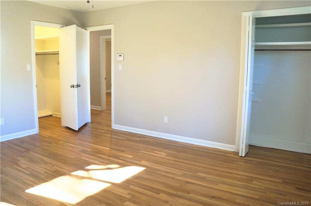330 Whitestone Road Charlotte, NC 28270 - Photo 10 of 23 a view of an empty room with wooden floor and a bathroom