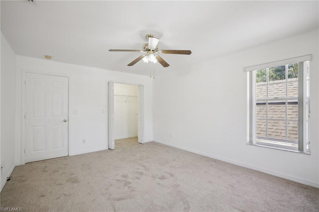 5348 Cypress Lane Naples, FL 34113 - Photo 25 of 28 a view of an empty room with a window