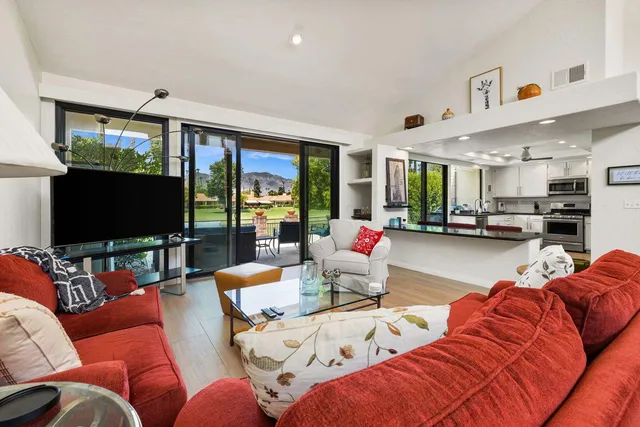 a bedroom with wooden floor and furniture