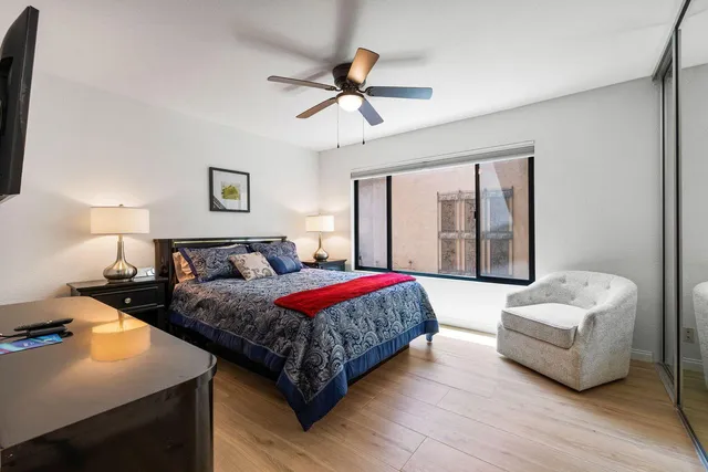 a living room with a bed furniture and a large window