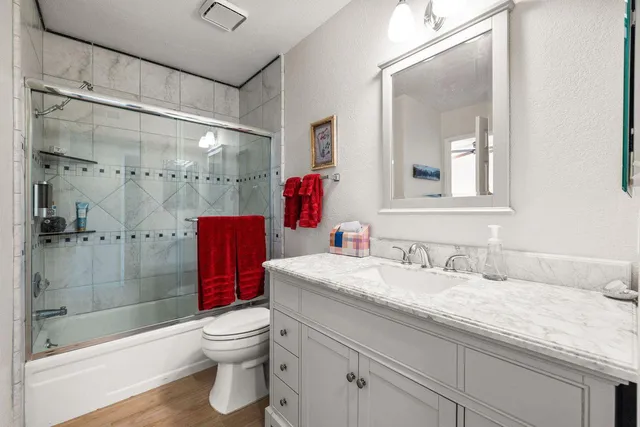 a bathroom with a sink toilet and shower