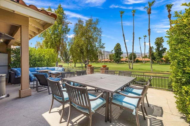 a view of a patio with table and chairs and potted plants