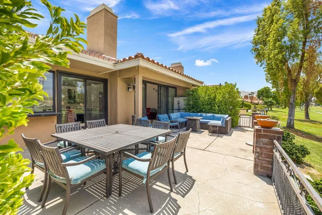 a view of a patio with table and chairs and potted plants