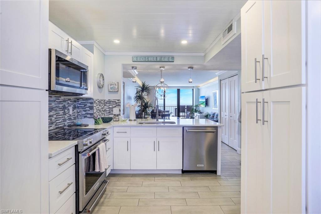 440 Seaview Court, Unit 1805 Marco Island, FL 34145 - Photo 13 of 25 a kitchen with stainless steel appliances granite countertop a sink and cabinets