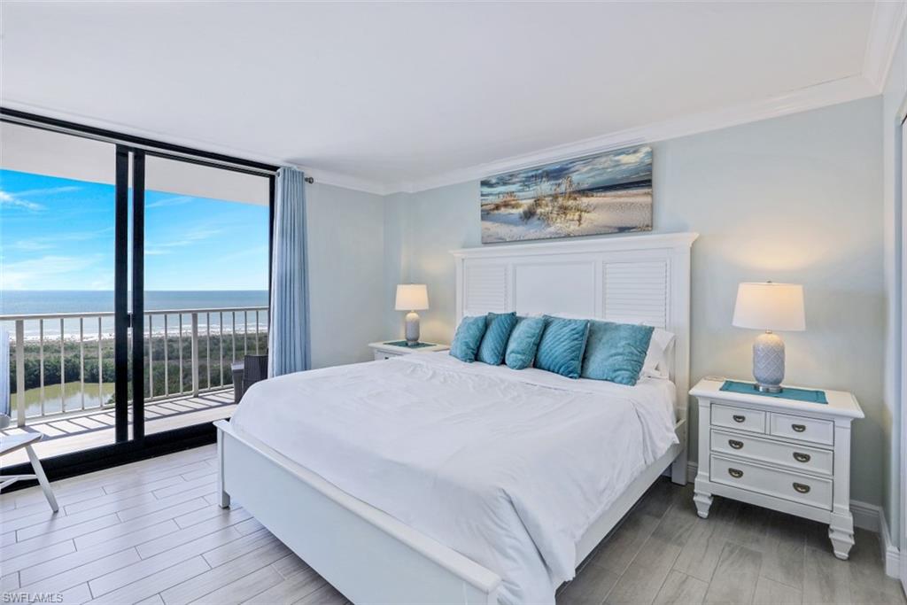 440 Seaview Court, Unit 1805 Marco Island, FL 34145 - Photo 16 of 25 a large white bed in a bedroom next to a window