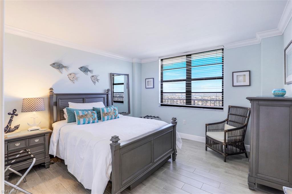 440 Seaview Court, Unit 1805 Marco Island, FL 34145 - Photo 19 of 25 a bedroom with a bed and a chair