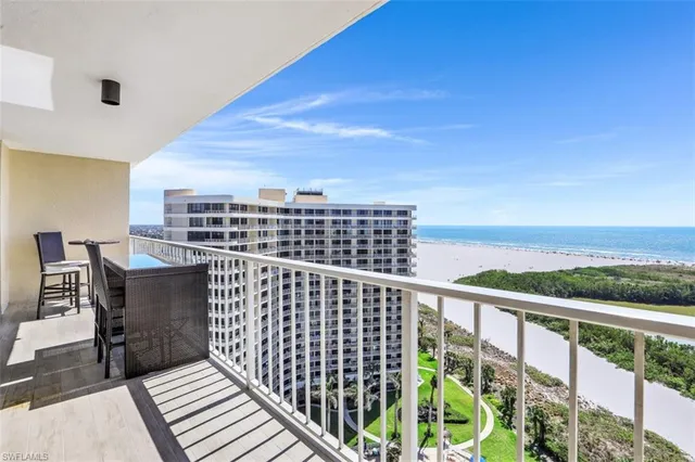 a view of a balcony with wooden floor and city view