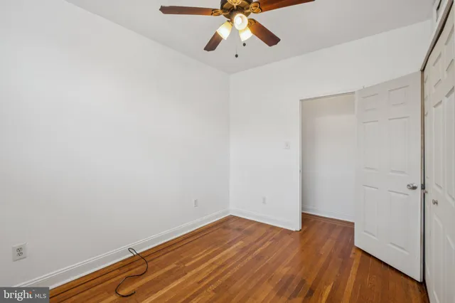 a view of room with hardwood floor and ceiling fan