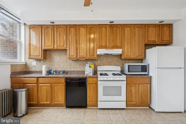 a kitchen with stainless steel appliances granite countertop a stove sink and cabinets