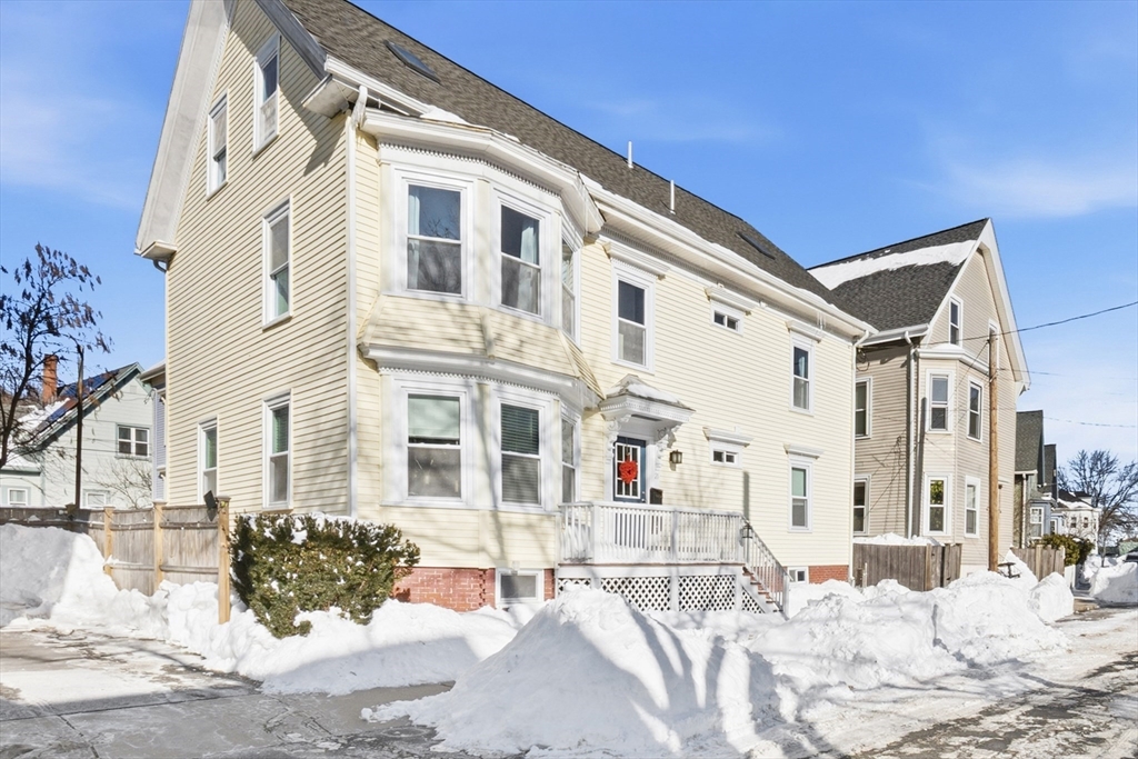 a view of a house with snow on the road
