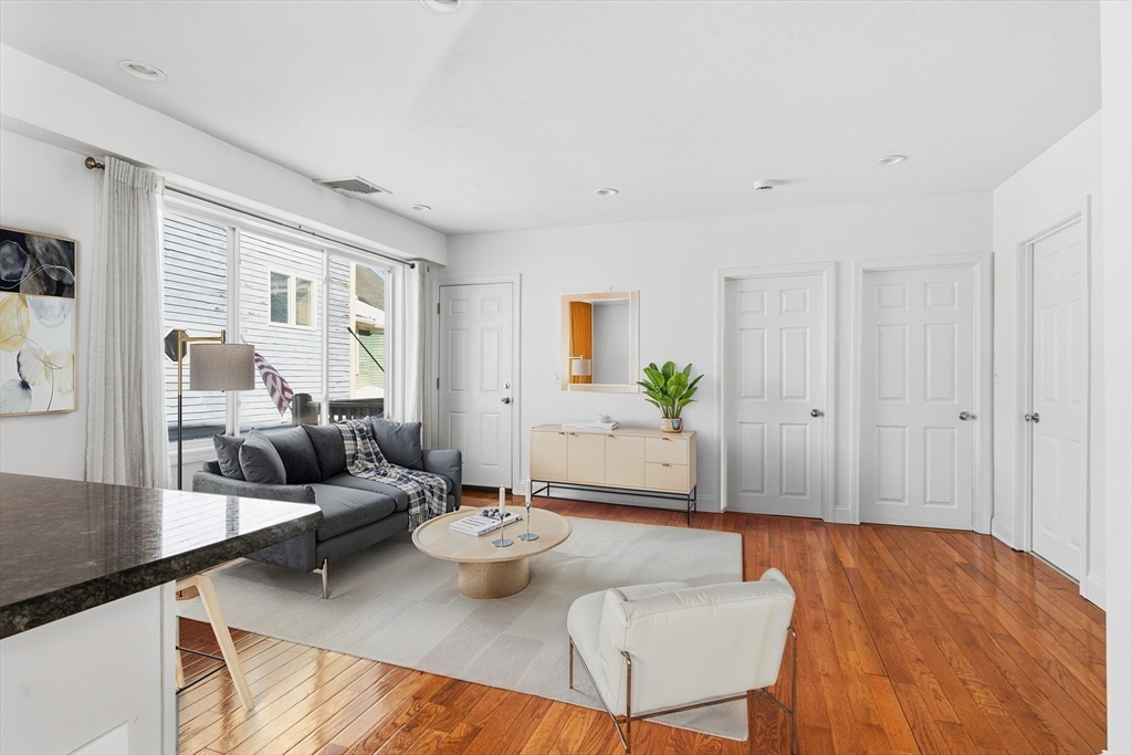 21 Emerton Street, Unit 2 Salem, MA 01970 - Photo 13 of 33 a living room with furniture and wooden floor