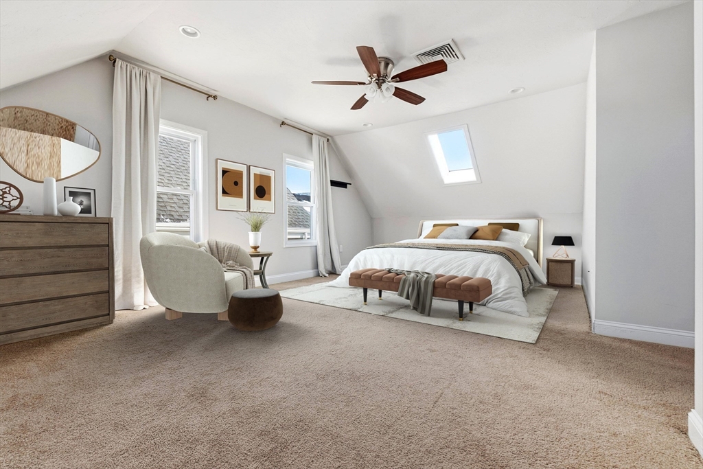 21 Emerton Street, Unit 2 Salem, MA 01970 - Photo 24 of 33 a bedroom with a bed and a chandelier