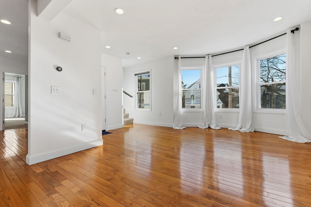 21 Emerton Street, Unit 2 Salem, MA 01970 - Photo 4 of 33 a view of an empty room with window and wooden floor