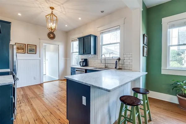 a view of kitchen and sink with wooden floor