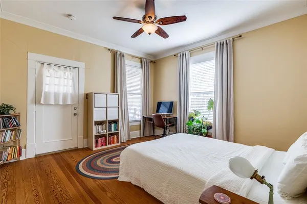 a bedroom with a bed and a large window
