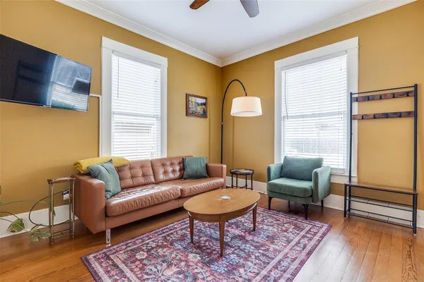 a living room with furniture a rug and a window