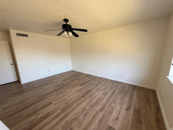 a view of a room with wooden floor and cabinet