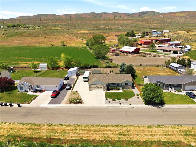72 Canal Bank Road Garland, UT 84312 - Photo 38 of 40 Single-story residence featuring a two-car garage, concrete driveway, and front lawn