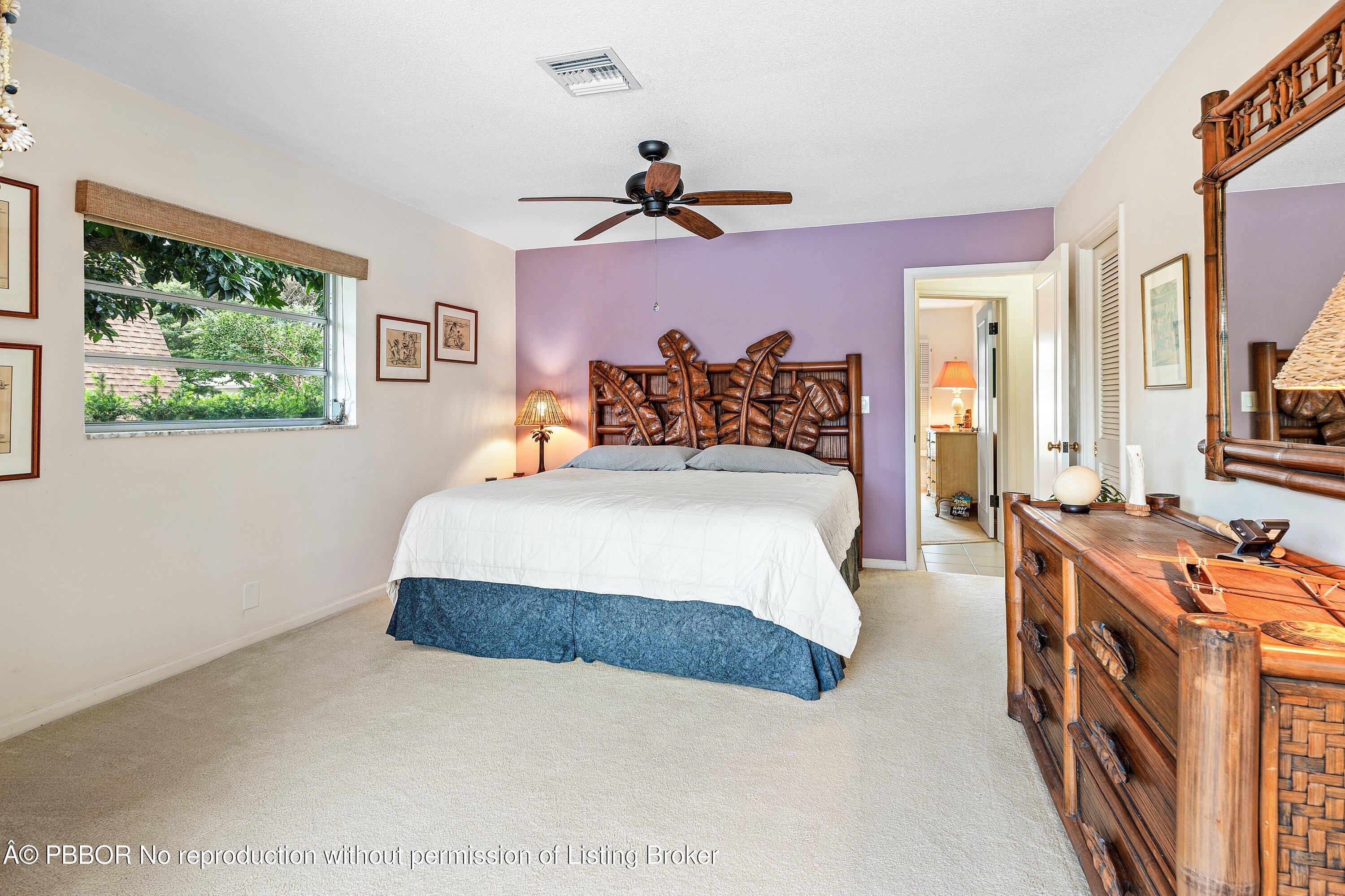 23 Sabal Island Drive Ocean Ridge, FL 33435 - Photo 13 of 16 a bedroom with a bed and a chandelier
