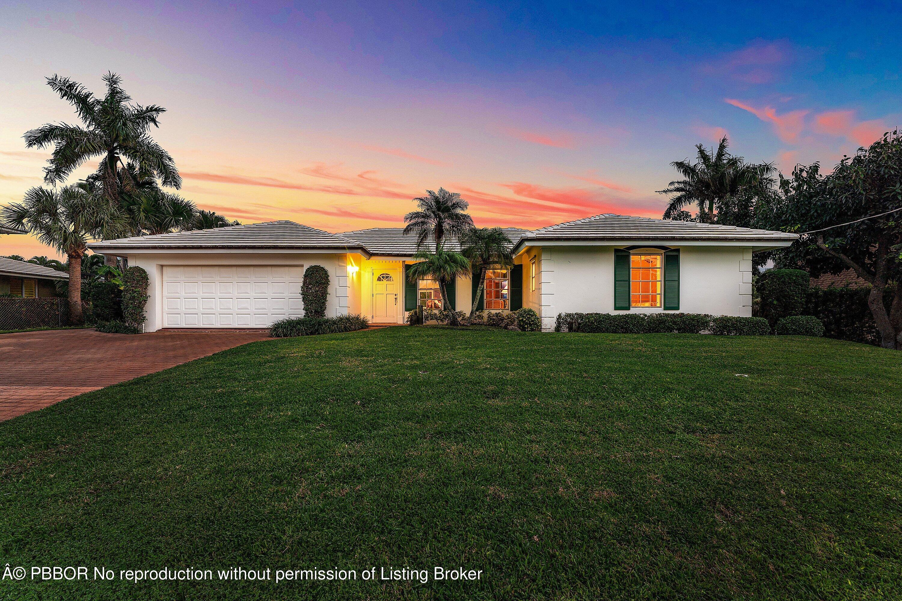 23 Sabal Island Drive Ocean Ridge, FL 33435 - Photo 5 of 16 a front view of house with a garden