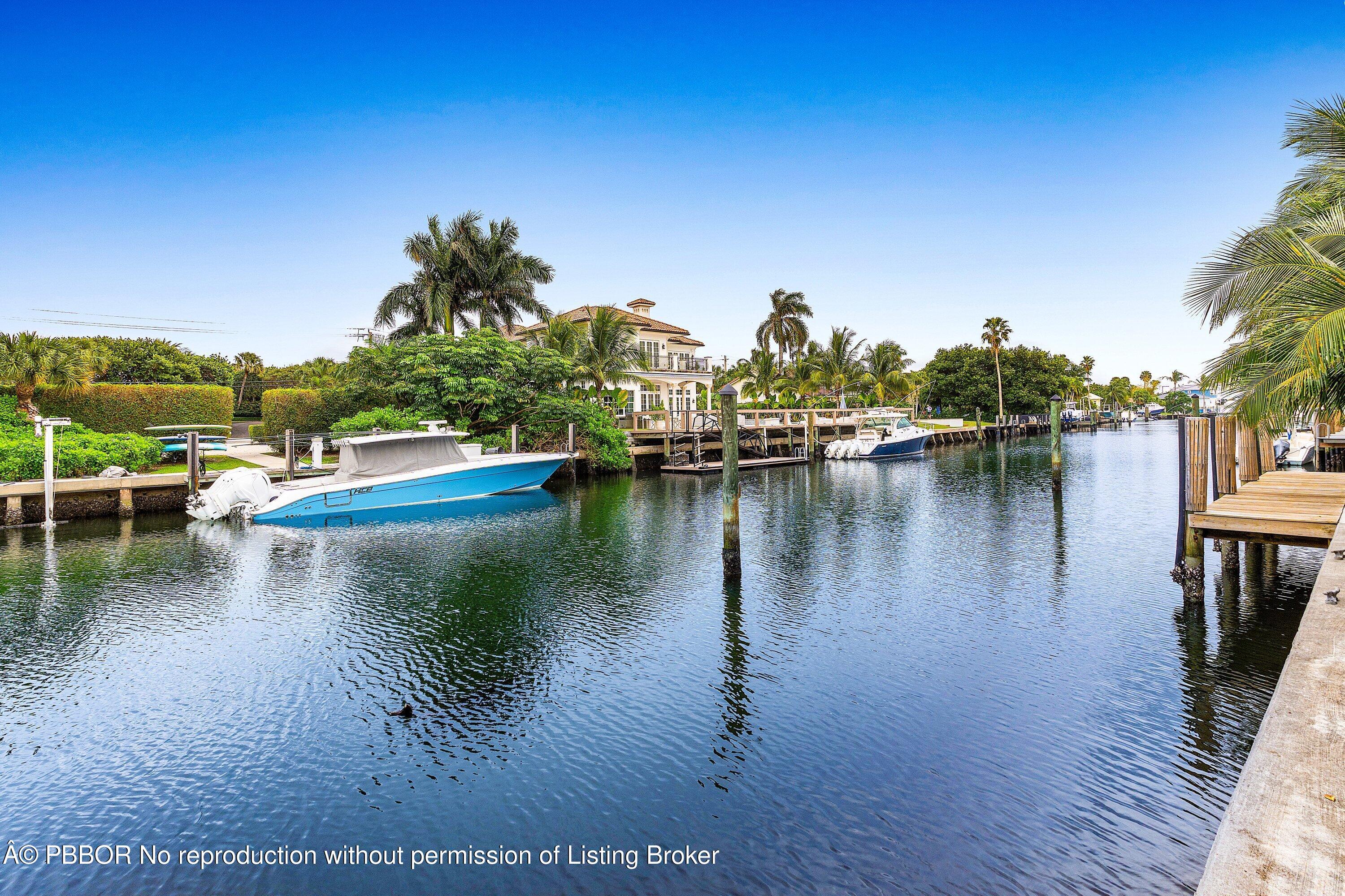 23 Sabal Island Drive Ocean Ridge, FL 33435 - Photo 6 of 16 a view of an ocean with boats and trees in the background